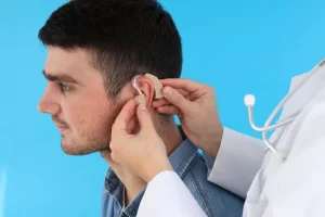 doctor-installs-hearing-aid